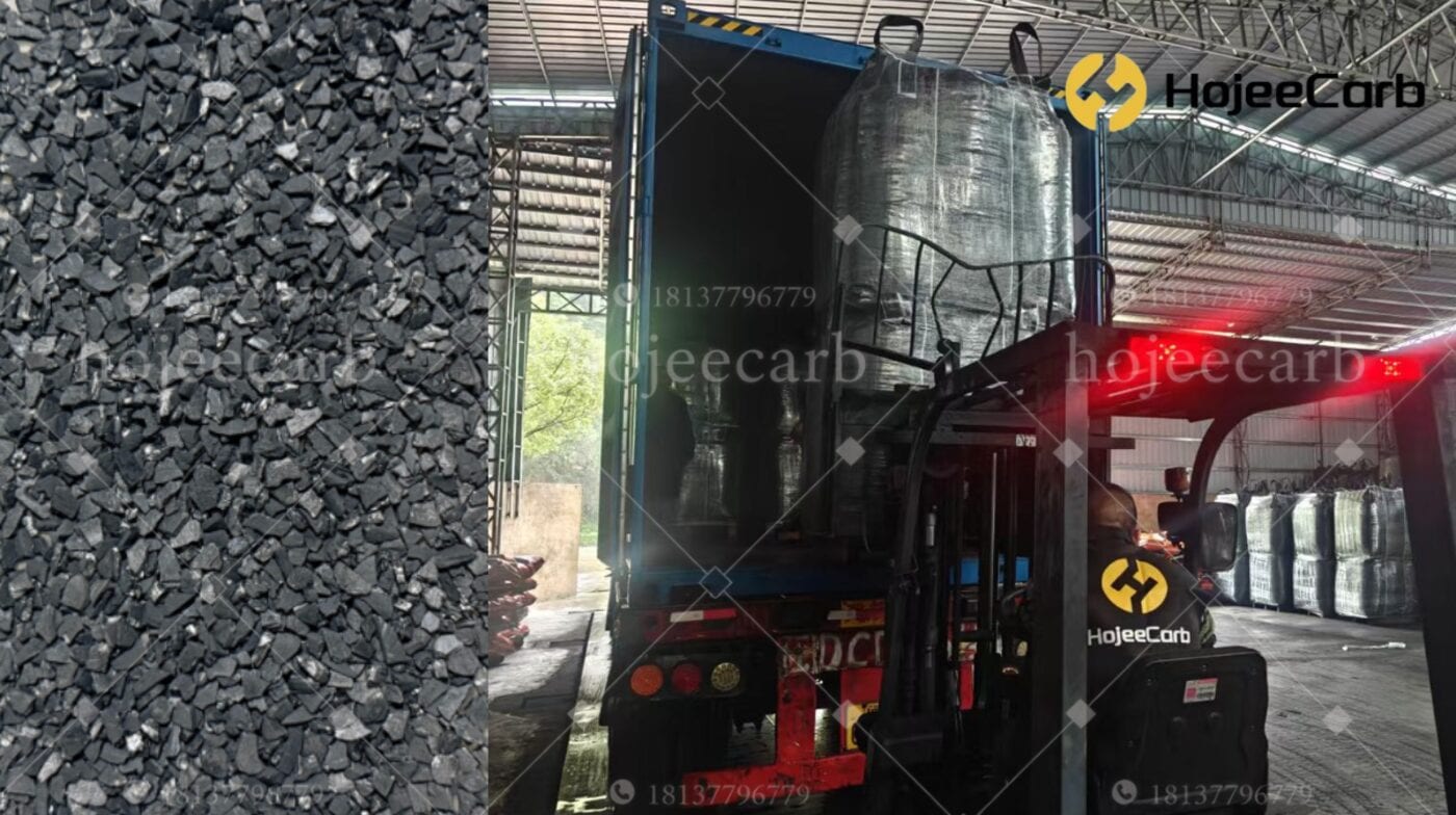 HojeeCarb activated carbon granules close-up alongside stacked FIBC bulk bags in a factory warehouse — gold recovery grade coconut shell carbon inventory ready for shipment to CIP and CIL mining operations