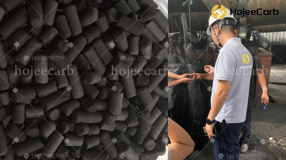 HojeeCarb worker in hard hat inspecting cylindrical activated carbon pellets at the manufacturing facility — quality control for mercury-grade sorbent