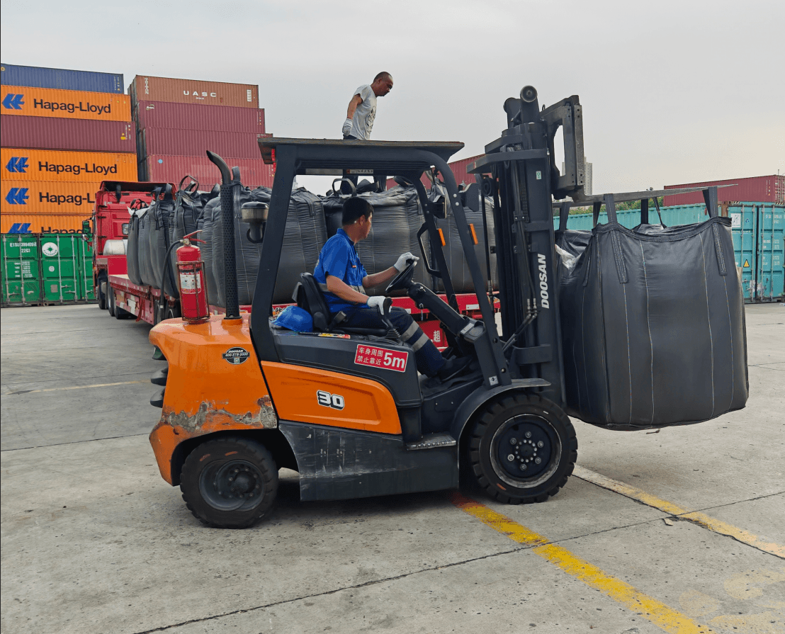 Loading activated carbon bulk bags at shipping port for refinery delivery