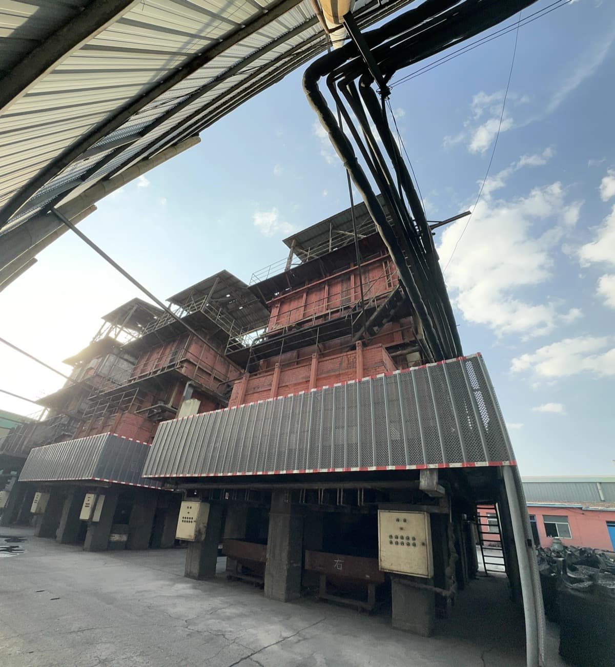 Panoramic view of activated carbon production facility with multiple activation furnaces