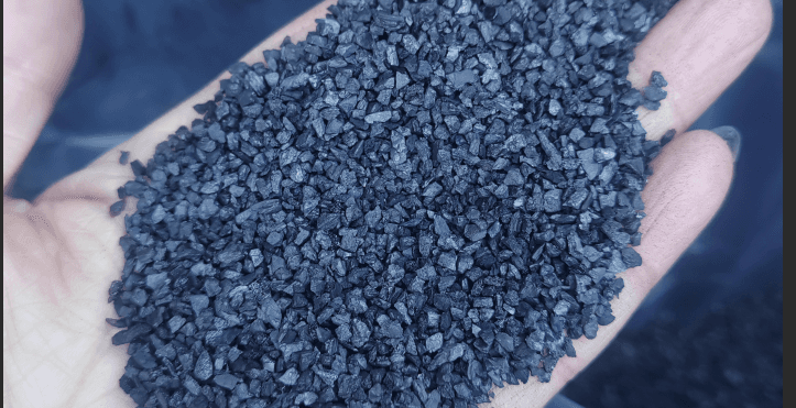 Bituminous coal-based granular activated carbon granules in hand — the raw material behind every Filtrasorb equivalent