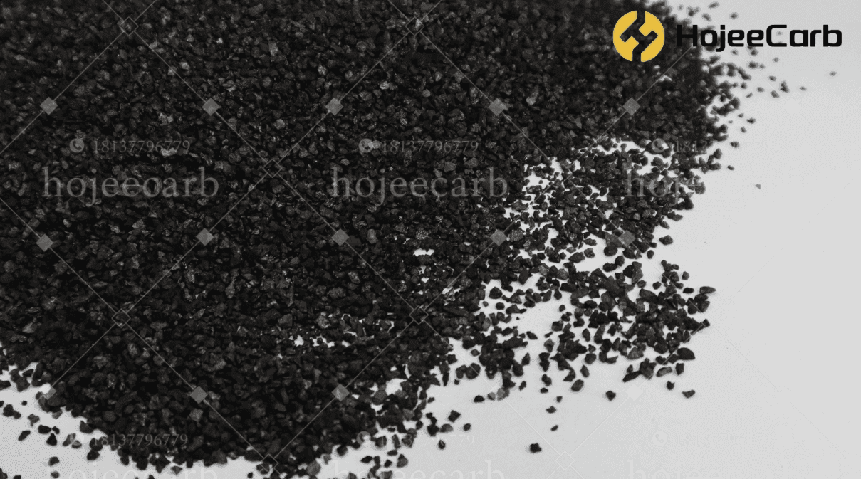 Black coal-based granular activated carbon scattered on a white background — HojeeCarb water treatment filter grade with coal gas and coal tar extracted before carbonisation for low bulk density and no colour bleed