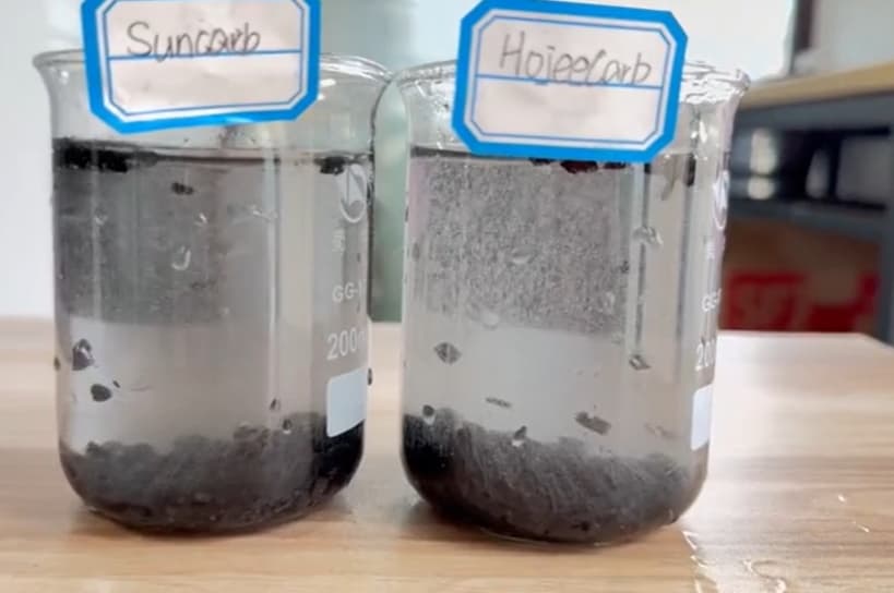 HojeeCarb vs SunCarb coconut shell carbon bubbling test — fine air bubbles rising from granules in water