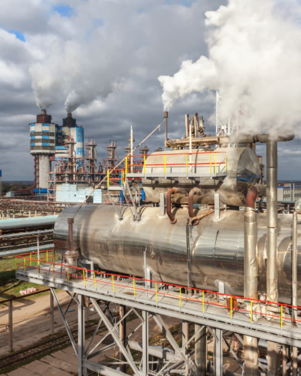 Industrial chemical plant using impregnated activated carbon for emission control and gas purification