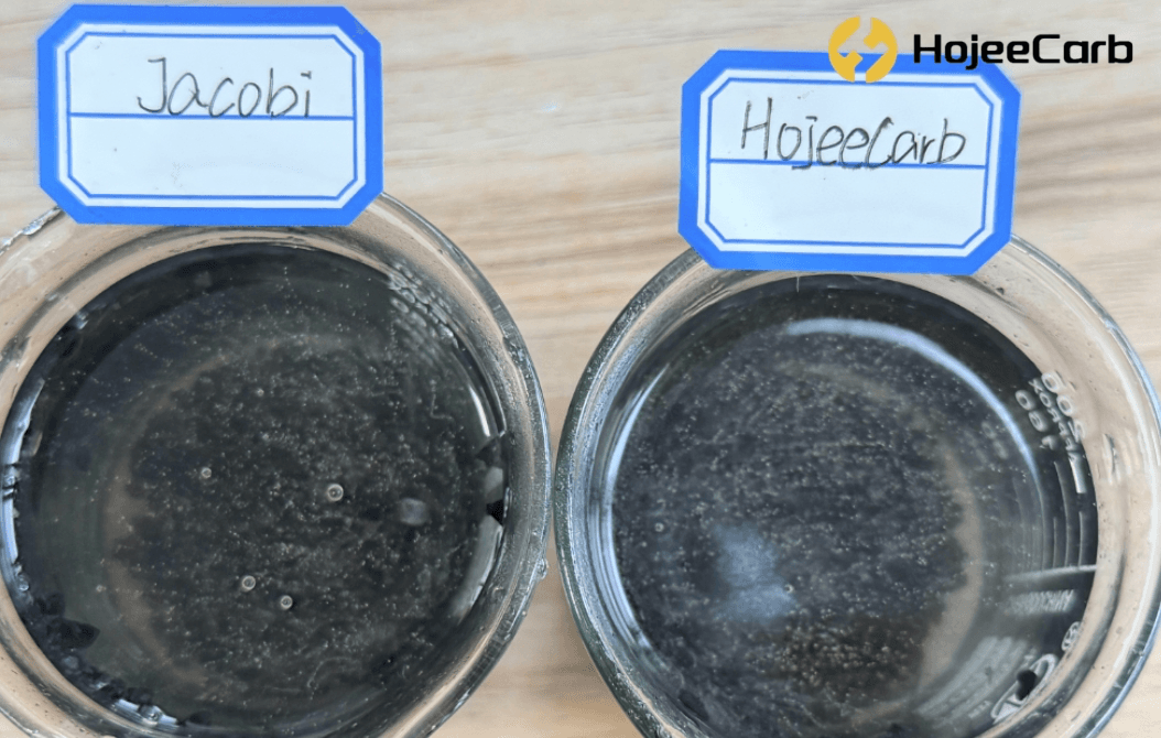 Jacobi vs HojeeCarb coconut shell carbon bubbling test — fine air bubbles rising from granules in water