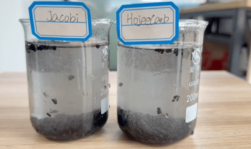 Jacobi vs HojeeCarb coconut shell carbon bubbling test — fine air bubbles rising from granules in water