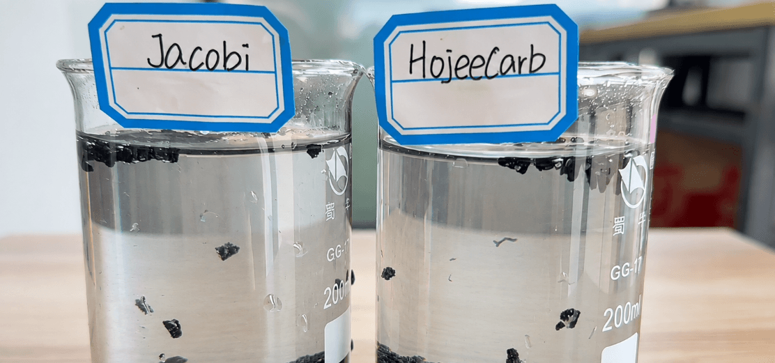 Jacobi vs HojeeCarb coconut shell carbon water clarity test — clear water above granule samples