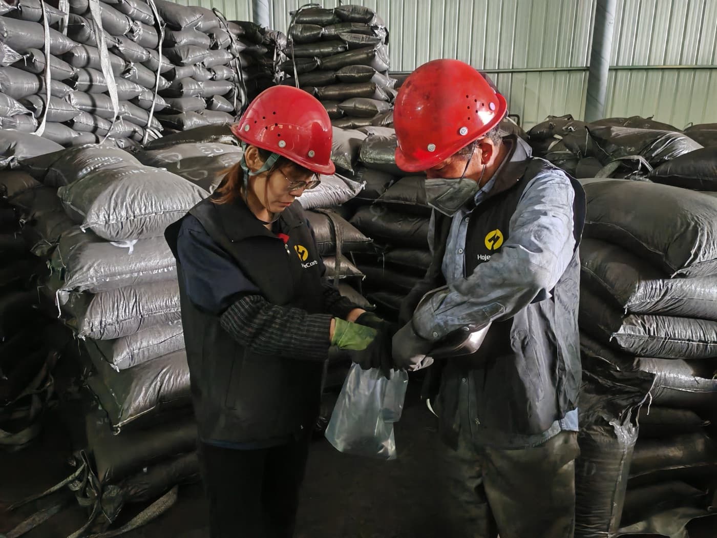 HojeeCarb team sampling 100 tons of coal-based columnar activated carbon before shipment to Norway