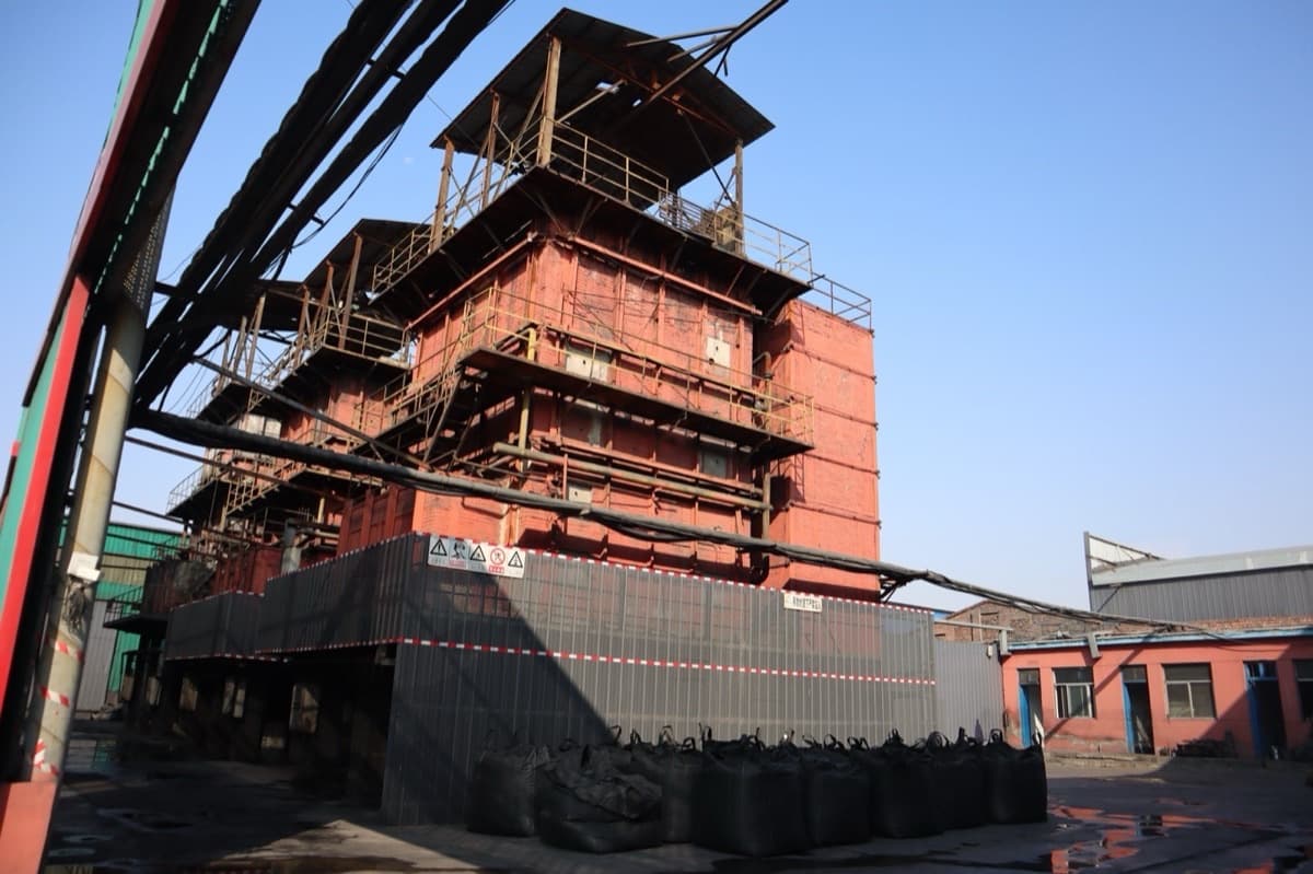 Activated carbon production workshop showing high-temperature kilns similar to reactivation furnaces