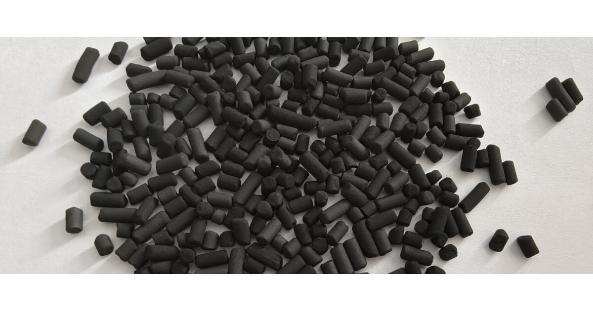 CuO/MgO impregnated activated carbon black cylindrical pellets spread on a white background