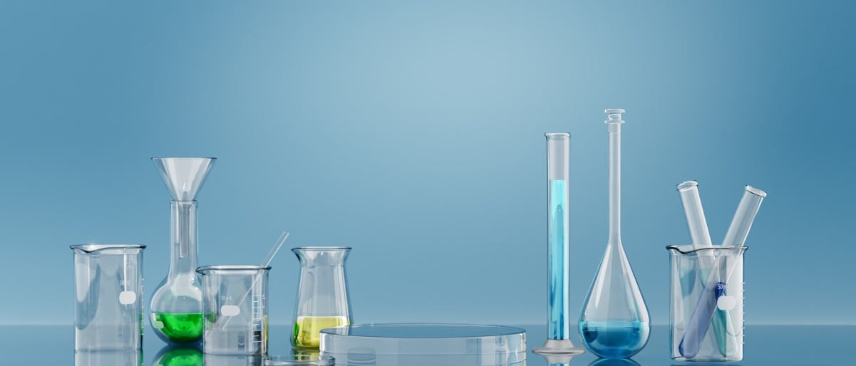 Laboratory glassware with colorful chemical solutions representing K₂CO₃ activated carbon research and development