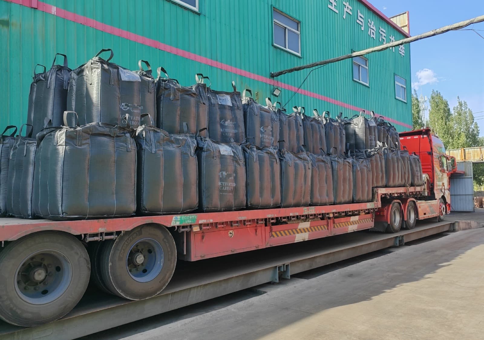 Activated carbon jumbo bags on a truck at the factory weighbridge