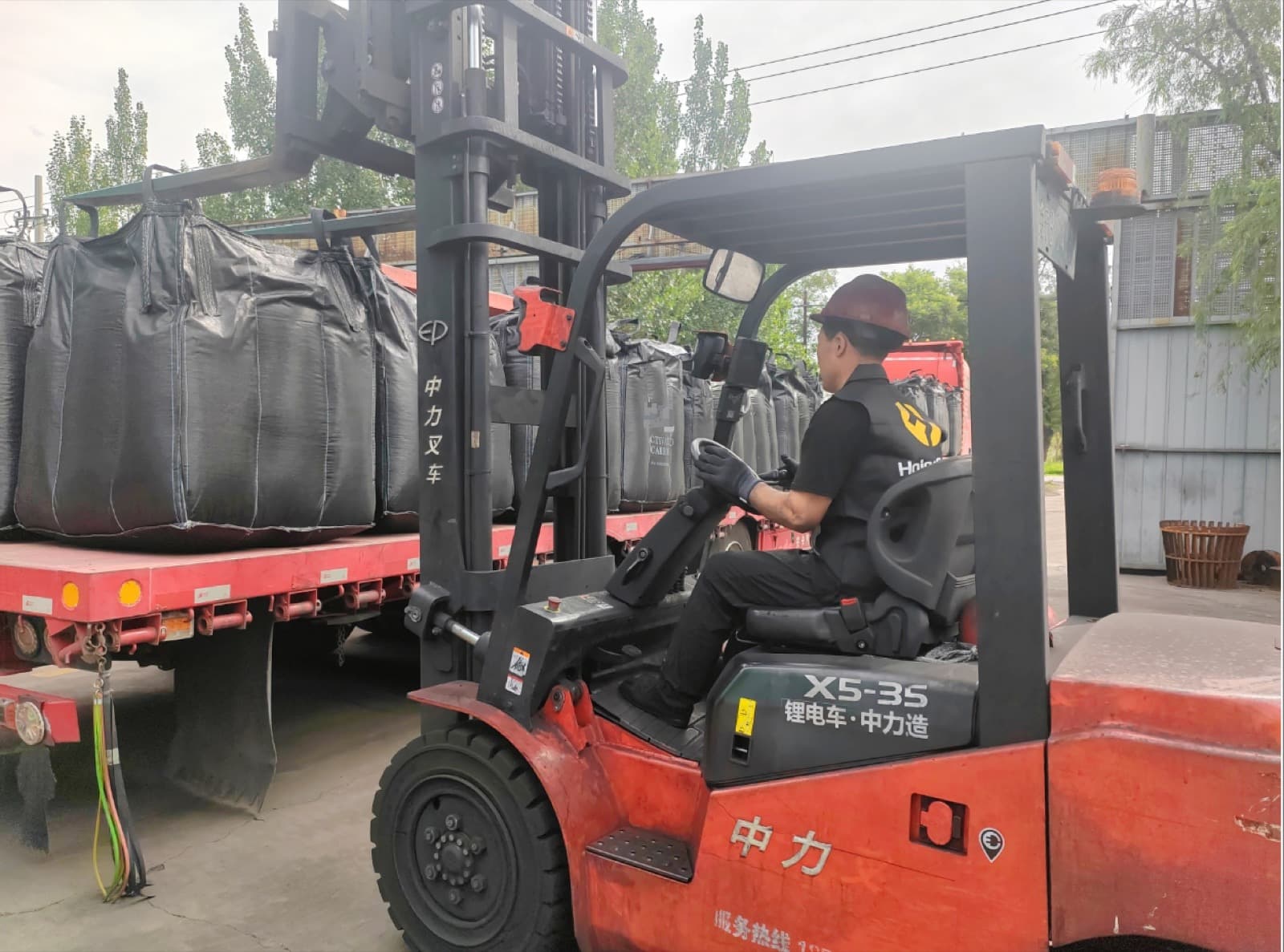 Bulk jumbo bags of activated carbon loaded onto a truck at the factory