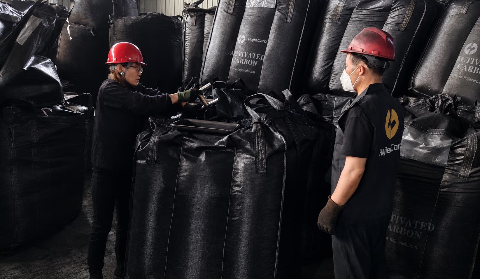 HojeeCarb warehouse staff handling activated carbon bulk bags